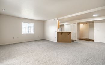 Empty room with a window and a door.